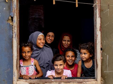 Little girls standing in the window frame