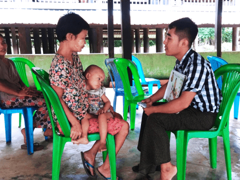 Instruction on the proper feeding of RUTF and IYCF counselling to mother of child with MAM treated at outreach clinic, Kangyidaunt by staff