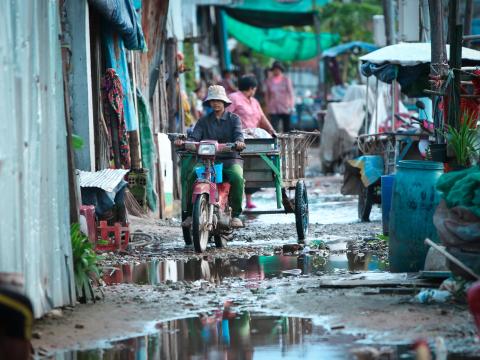 Young adult makes their was through a crowded street in Cambodia