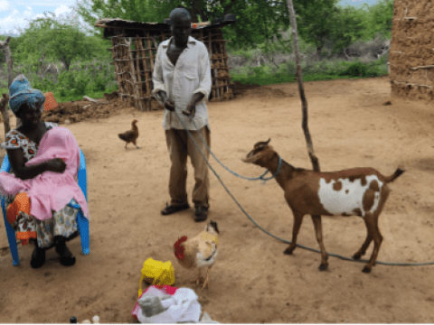 Jennifer sits outside her house with her brother and baby, Benjamin in Kitui Kenya