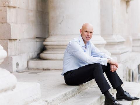 Andrew Morley President and CEO of World Vision International sitting on steps