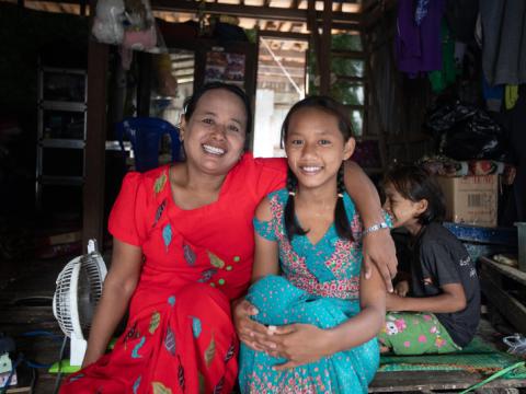 Ei and her mother sit together in their home