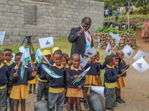 Group of children waving Lesotho flags