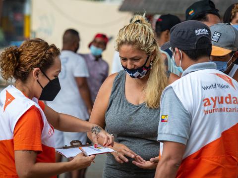 Venezuela Migrant Crisis staff distributing vouchers