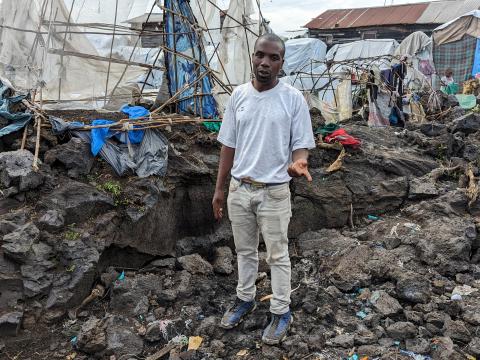 Innocent standing where his sheltet was built