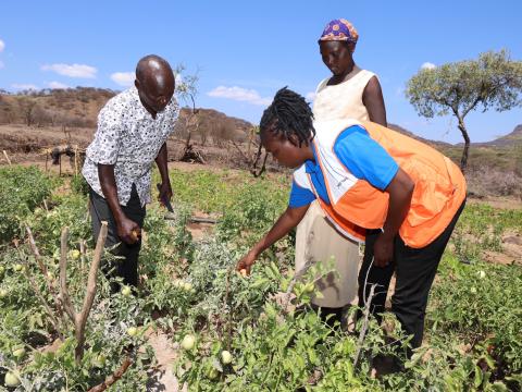 Lorus and his wife with some of the produce from their farm following World Vision’s introduction of small-scale irrigation farming to the community 