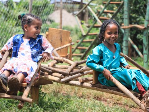 Children smiling and playing at a playground