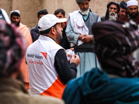 World Vision staff handing out seeds in a response