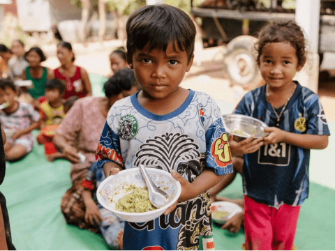 Boy holding a bowl of food