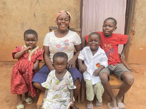 Josaphat in red t-shirt, with his mother and siblings