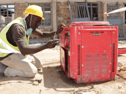 Joshua Lomuria, one of the youths supported by the IMARA Programme to pursue vocational training, is assessing a generator for one of his electrical projects in Kainuk, Turkana County.