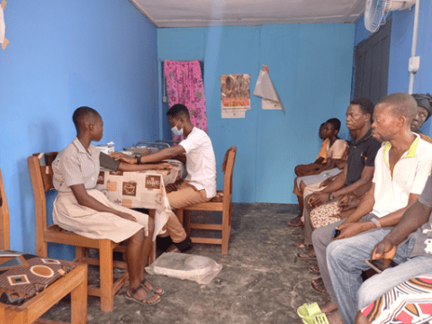 Dodo Tamale COMM together with the health workers at the health facility.