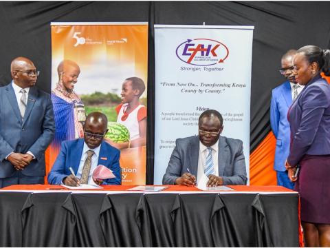 World Vision Kenya's National Director, Gilbert Kamanga (left), and EAK Board Vice-Chairperson, Dr. Robert Langat (right), sign a Memorandum of Understanding at World Vision Kenya headquarters in Nairobi. © World Vision Photo | Samuel Kisambe