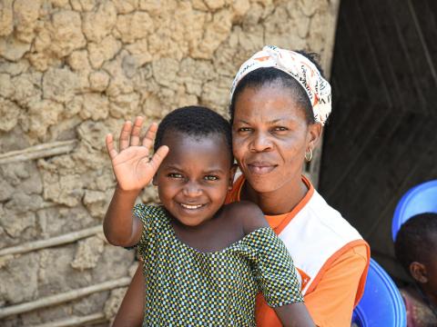 Justline recovered from malnutrition with World Vision staff