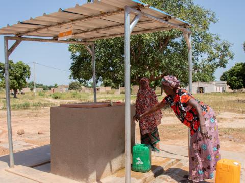 Pascaline getting water from one of the standpipes installed in Rouemtenga. 