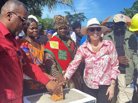 The US Ambasador laying the foundation stone for a bakery construction