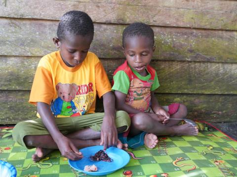 two boys eat lunch together