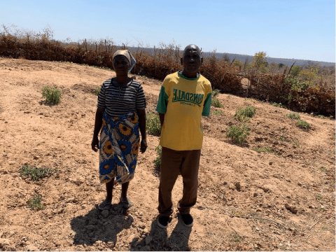 Mambowatema posing for a picture with one of his wife