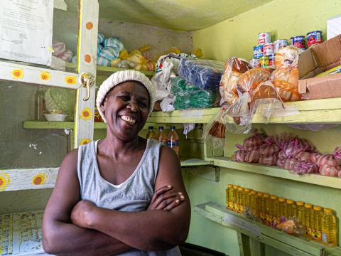 Milienne, a mother of five, stands inside her small shop