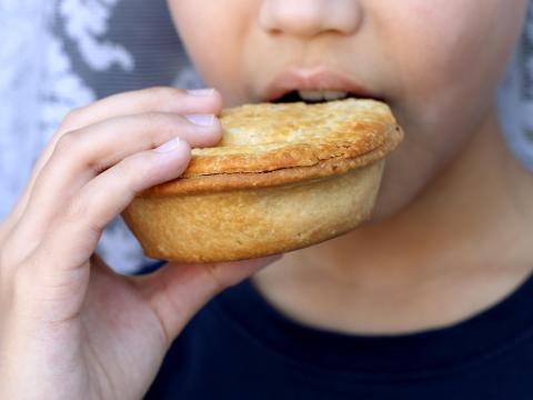 Child eating pie Alisha Arif / Alamy Stock Photo