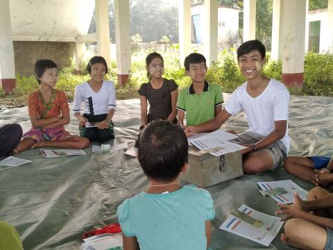 Myo conducts a child savings group activity