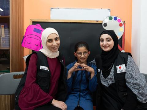 Dana happily posing with her teachers World Vision Syria Response, Joanna Zreineh