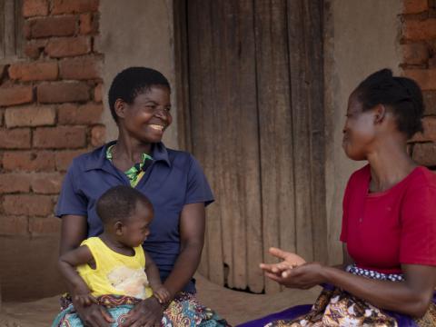 Ester Muheya, a Health Promoter, sensitising Mary on how to prevent malaria