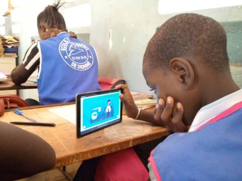 Kid learning with a tablet.