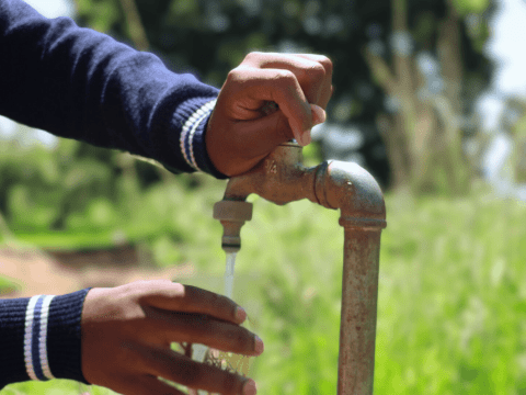 Nokukhanya fetching water from the tap.