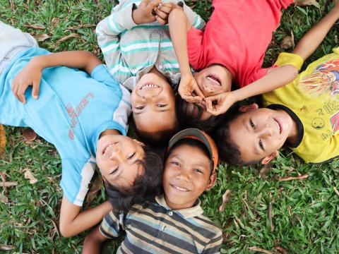 Children laying on the grass