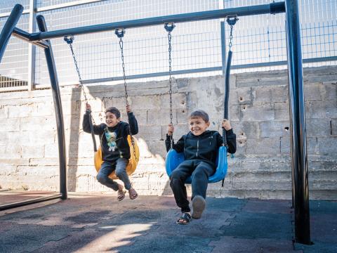 Palestinian Children playing with a new swing in the south of the West Bank