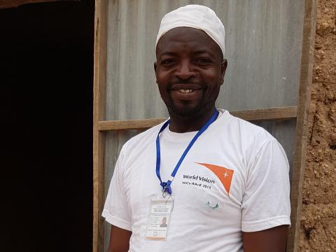 Moussa in front of his mini health post