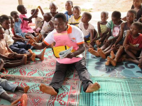 Elijah reads to children at a World Vision reading camp in Ghana
