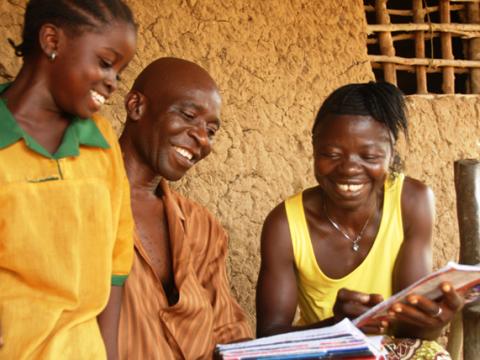 A community health worker monitor's a child's health during a visit to her home