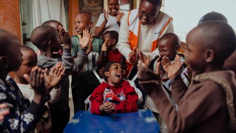 World Vision staff member with child with special needs in Kenya