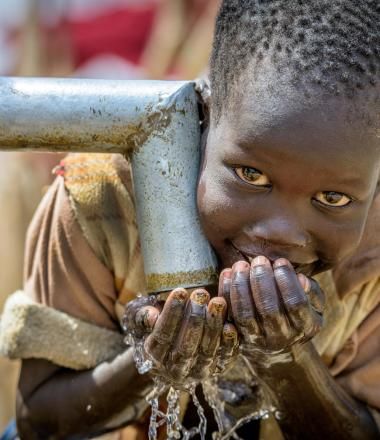 A Sudanese boy drinking clean water
