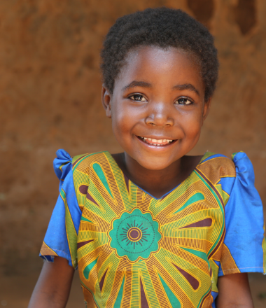 Smiling girl wearing a colorful shirt