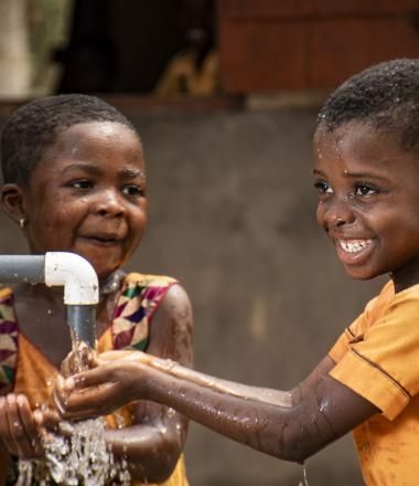 Two girls enjoying access to clean water