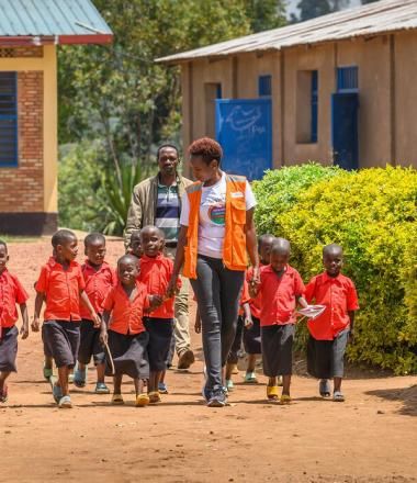 WV Rwanda Staff with Children