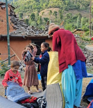 Children look at the items received from WVI Nepal