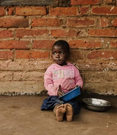 A girl eating from a bowl